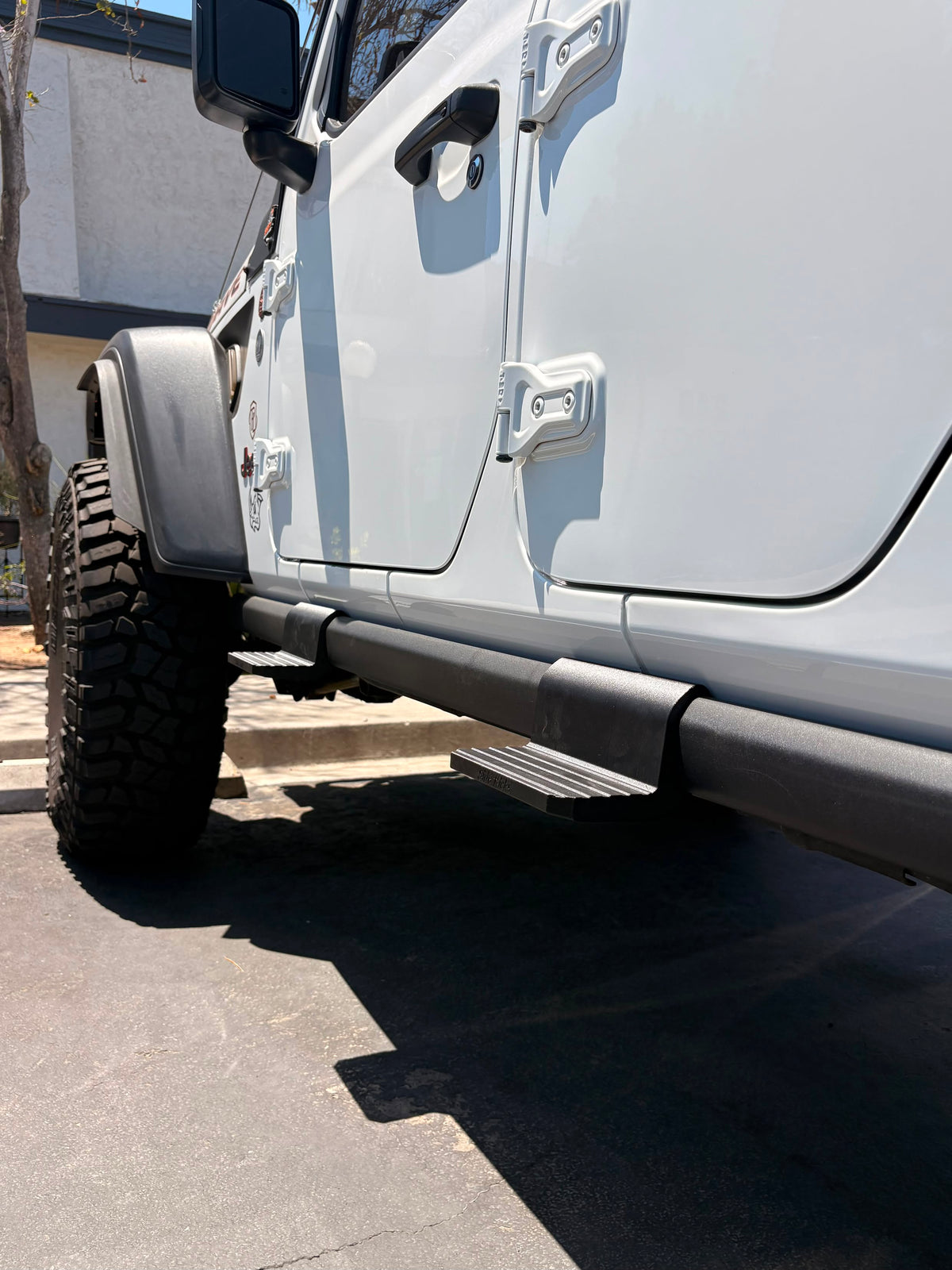 Silver Jeep with two ResilientZ mounted to its factory rock rail 